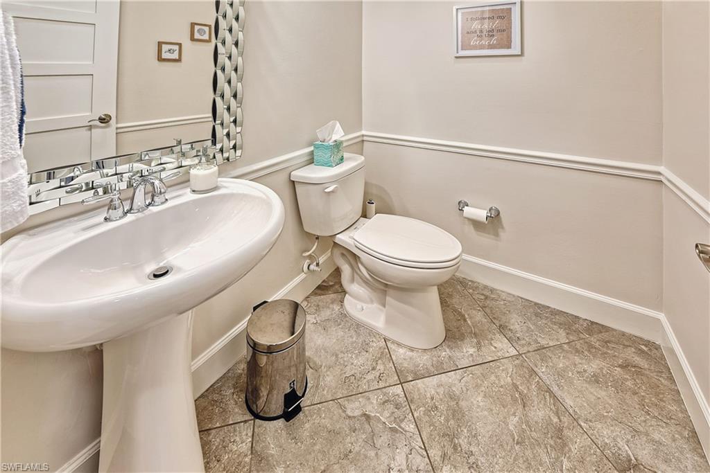 Bathroom with toilet and tasteful backsplash