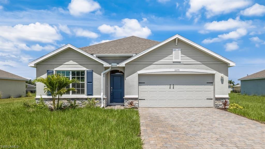 Model Home Contemporary stucco exterior with a stone veneer accent, featuring a blue entry door, decorative blue window shutters, and a two-car garage with an arched header