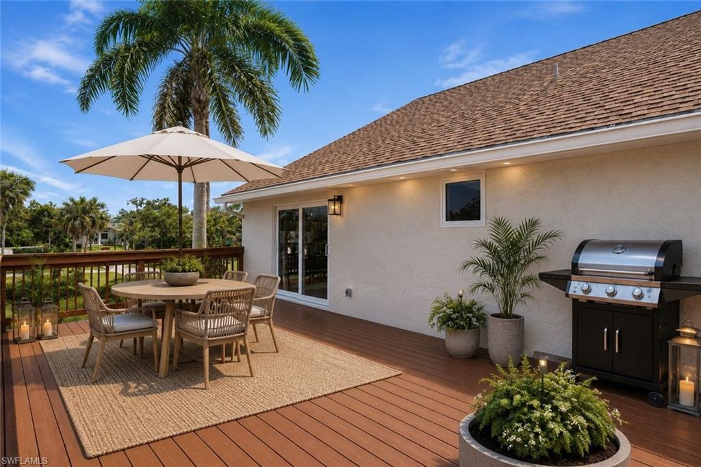 Spacious outdoor deck featuring wood-finish decking and a wooden railing