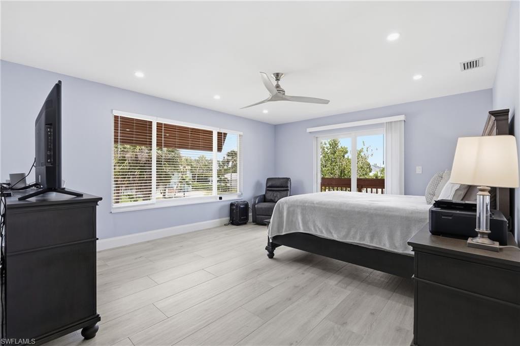 Bright interior featuring light wood-finish flooring, recessed lighting, and a modern ceiling fan