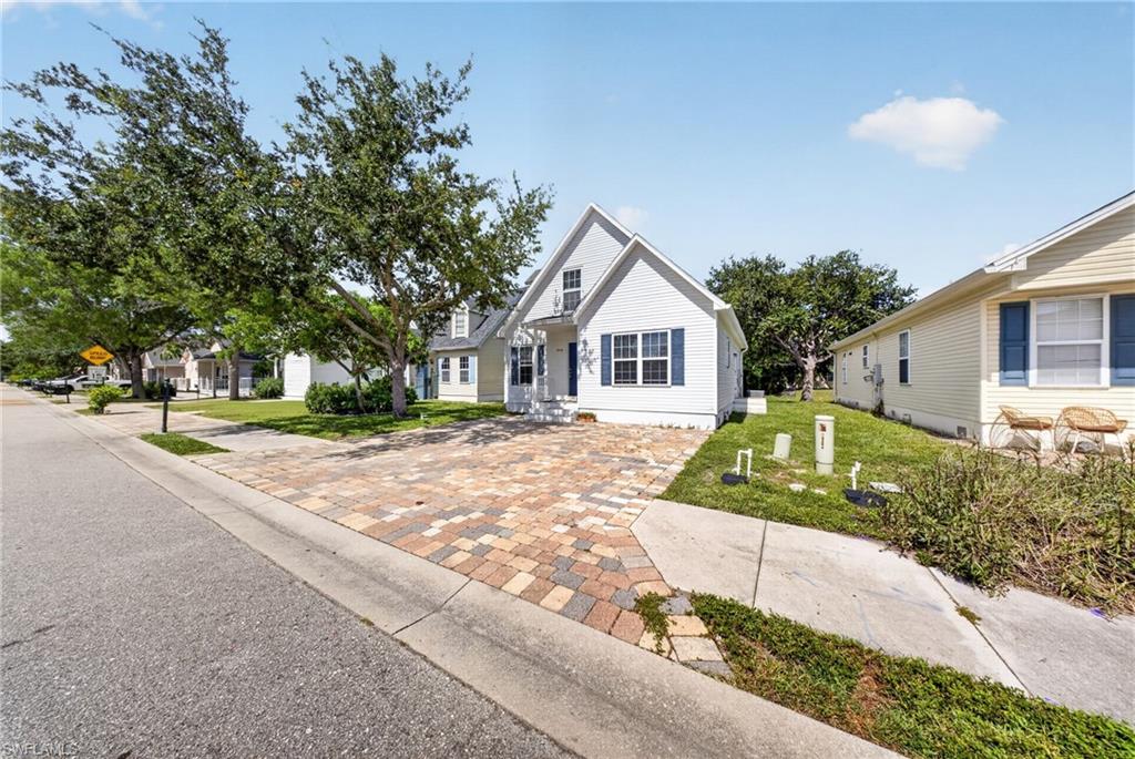 White exterior featuring blue shutters and a prominent gable roofline