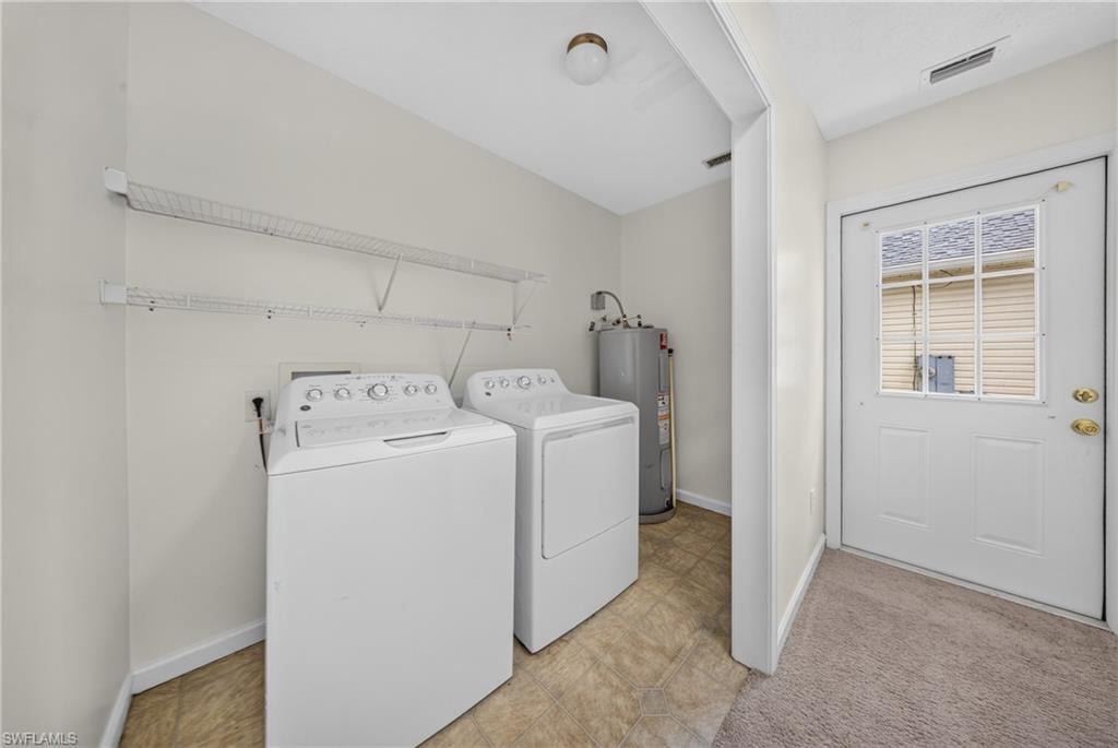 Utility area featuring wire shelving, a water heater closet, and a white exterior door with window panes