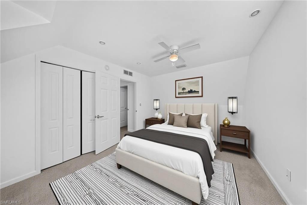 Bedroom featuring neutral-toned carpeting, white walls, recessed ceiling lighting, and a ceiling fan
