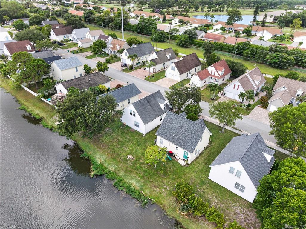 Residential neighborhood featuring a variety of single-family homes, mature trees, and a canal