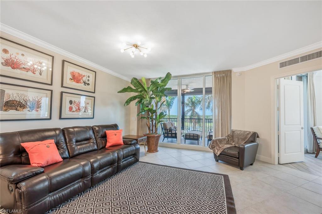 Bright living room with screened balcony access