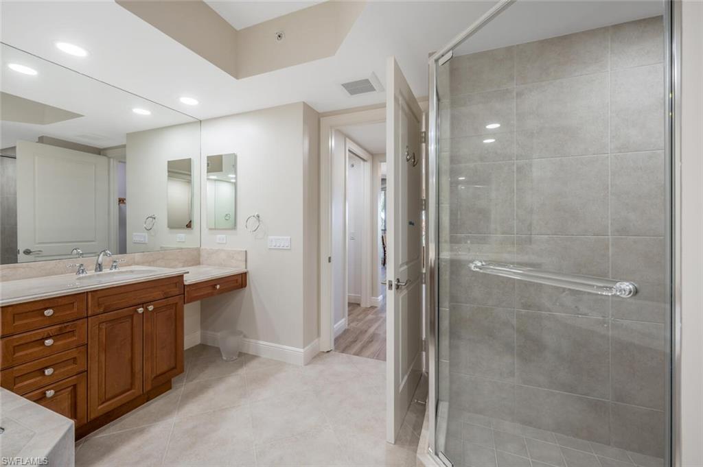 Separate shower & marble vanity area.
