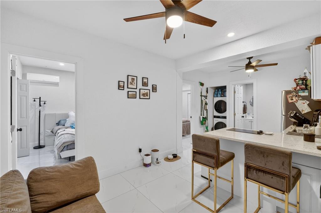 Kitchen area featuring a light-toned countertop, white cabinetry, and stainless steel appliances