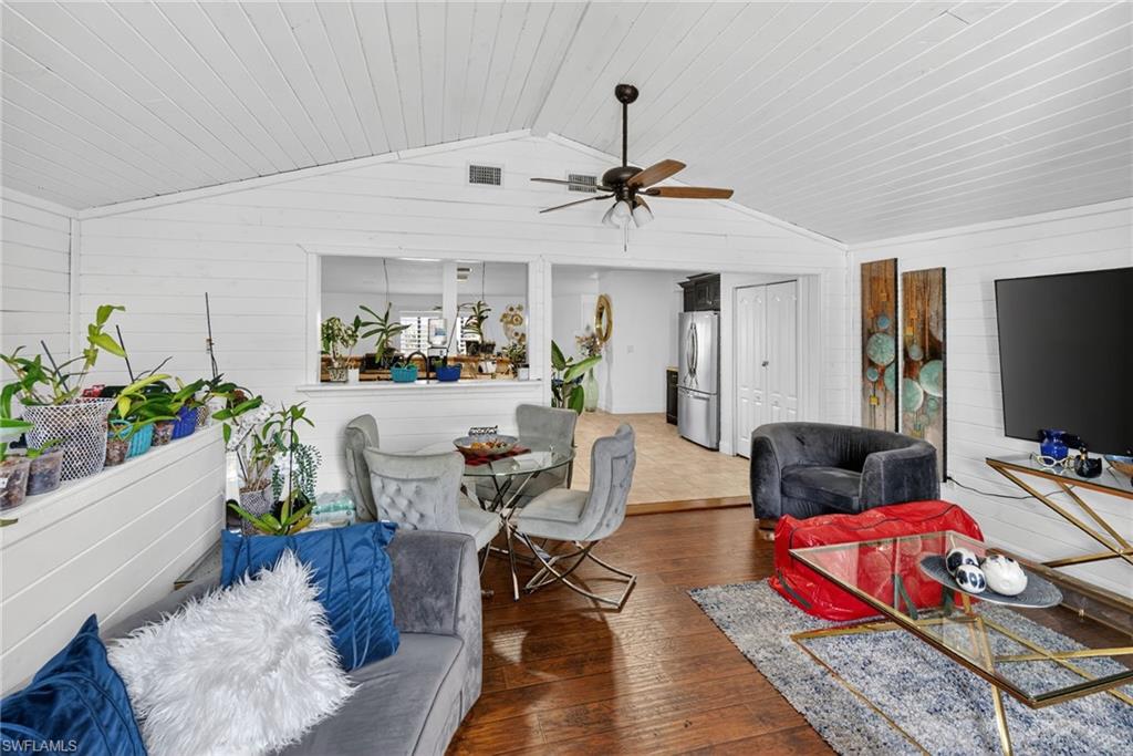 Vaulted white shiplap ceilings with a ceiling fan