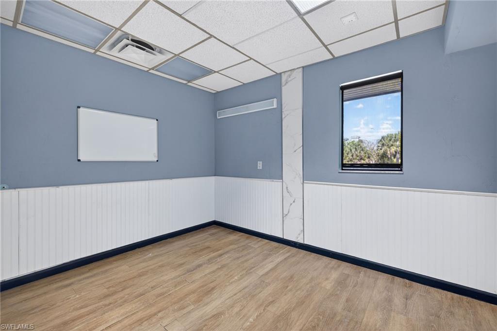 Interior room featuring wood-finish flooring and wainscoting