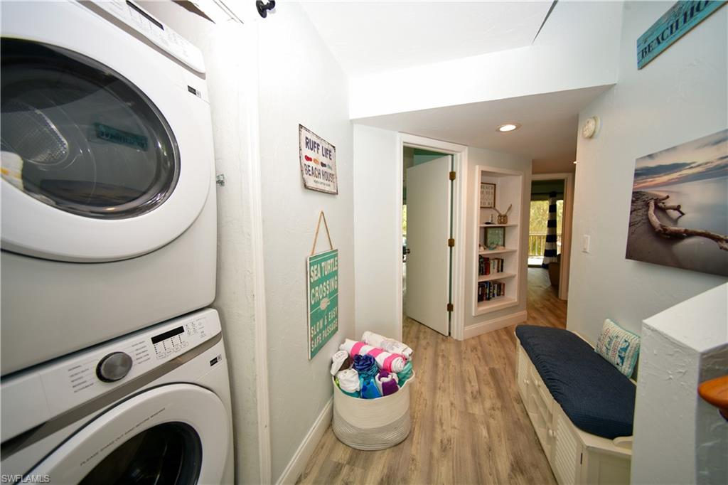 Dedicated laundry area featuring stacked washer and dryer units