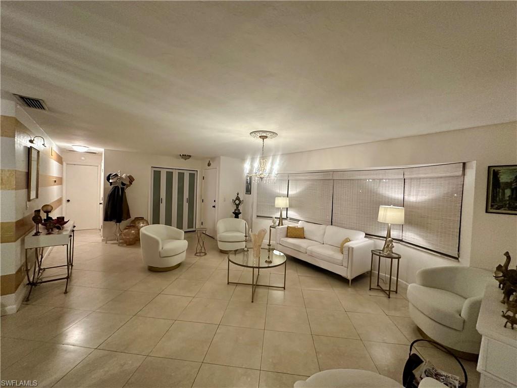 Spacious room featuring neutral-toned square tile flooring throughout
