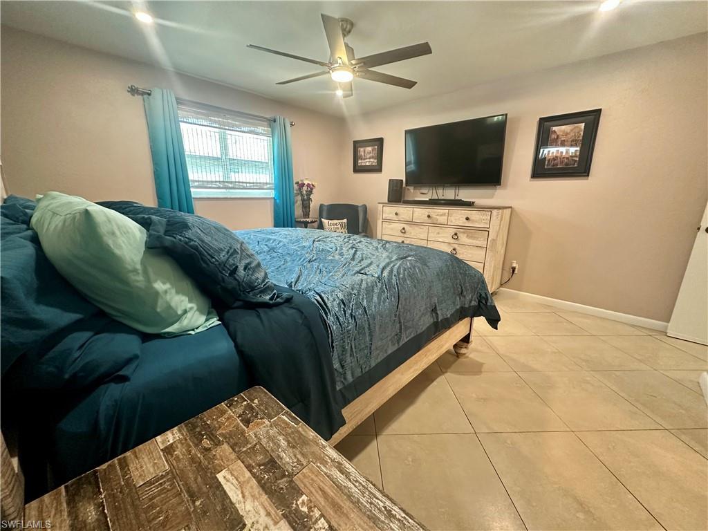 Room featuring light beige walls and large format tile flooring