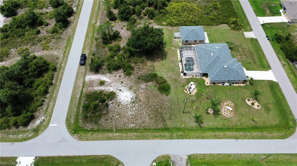 Single-story residence featuring a screened-in pool, an attached garage, and a detached outbuilding
