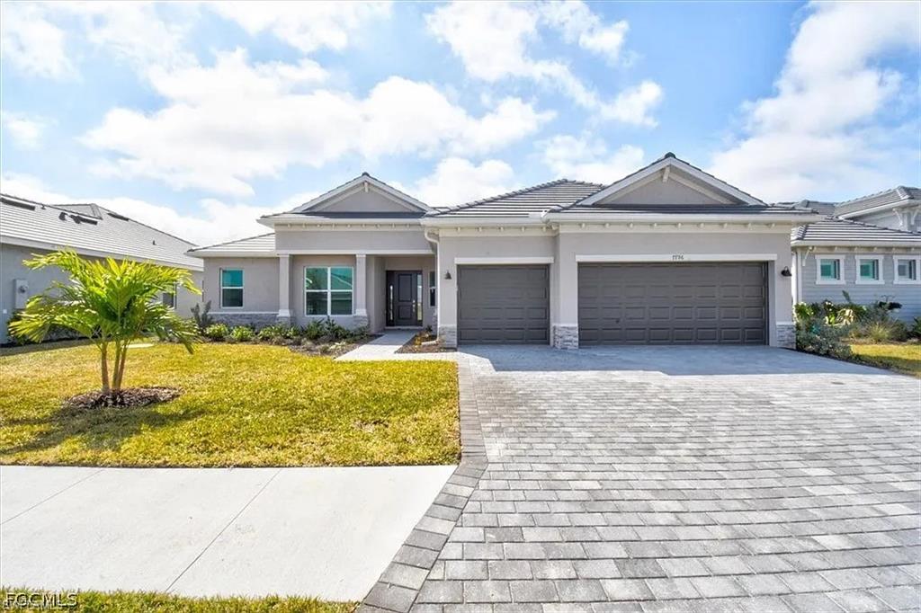 Contemporary-style single-story residence with a paver driveway