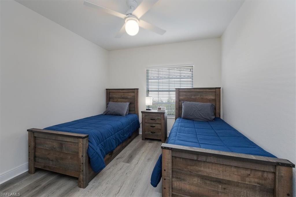 Bedroom featuring ceiling fan and light wood-type flooring