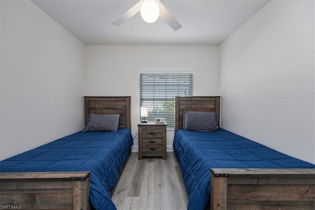 Bedroom with light hardwood / wood-style floors and ceiling fan