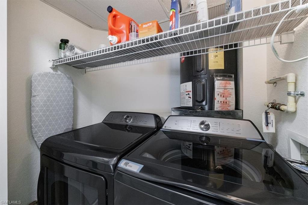 Clothes washing area featuring separate washer and dryer
