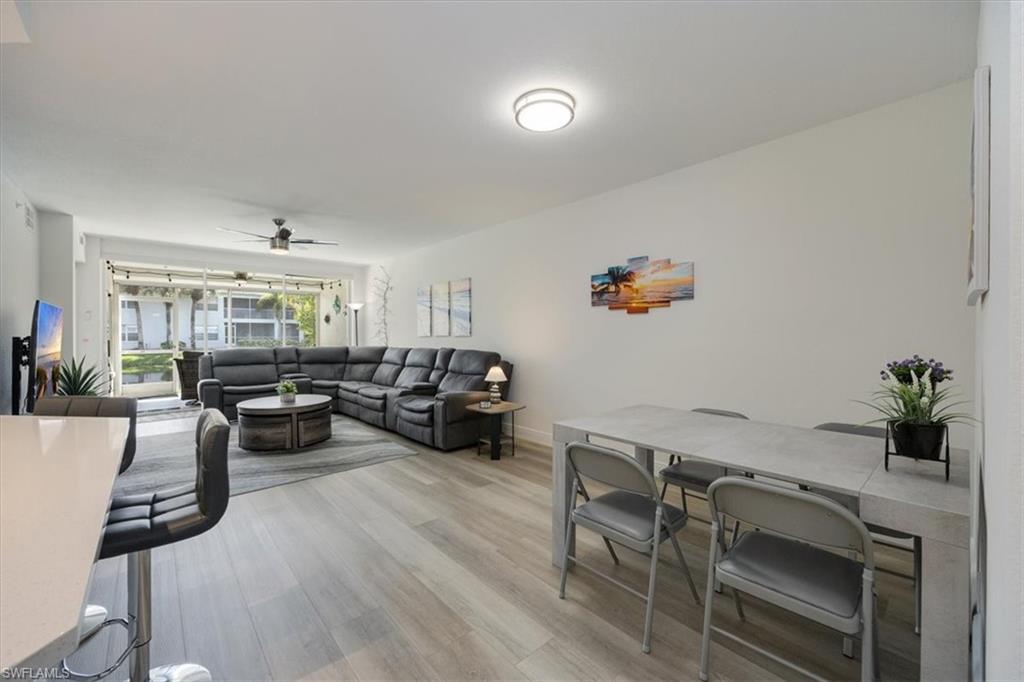 Living room featuring ceiling fan and light hardwood / wood-style flooring