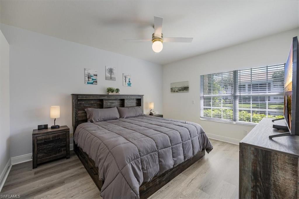 Bedroom with ceiling fan and hardwood / wood-style flooring