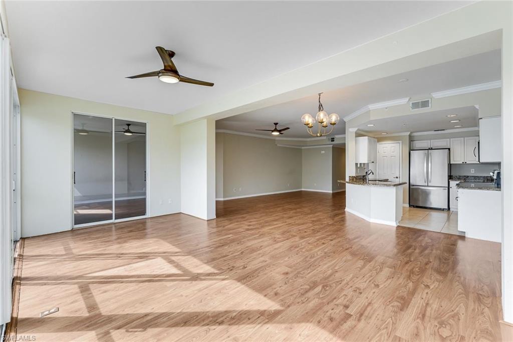 Open-concept living space featuring wood-finish flooring, recessed lighting, and a modern ceiling fan