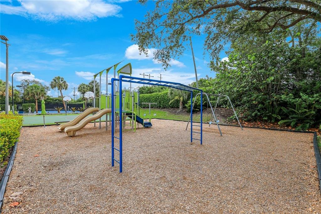 Community playground featuring multiple slides, monkey bars, and swings