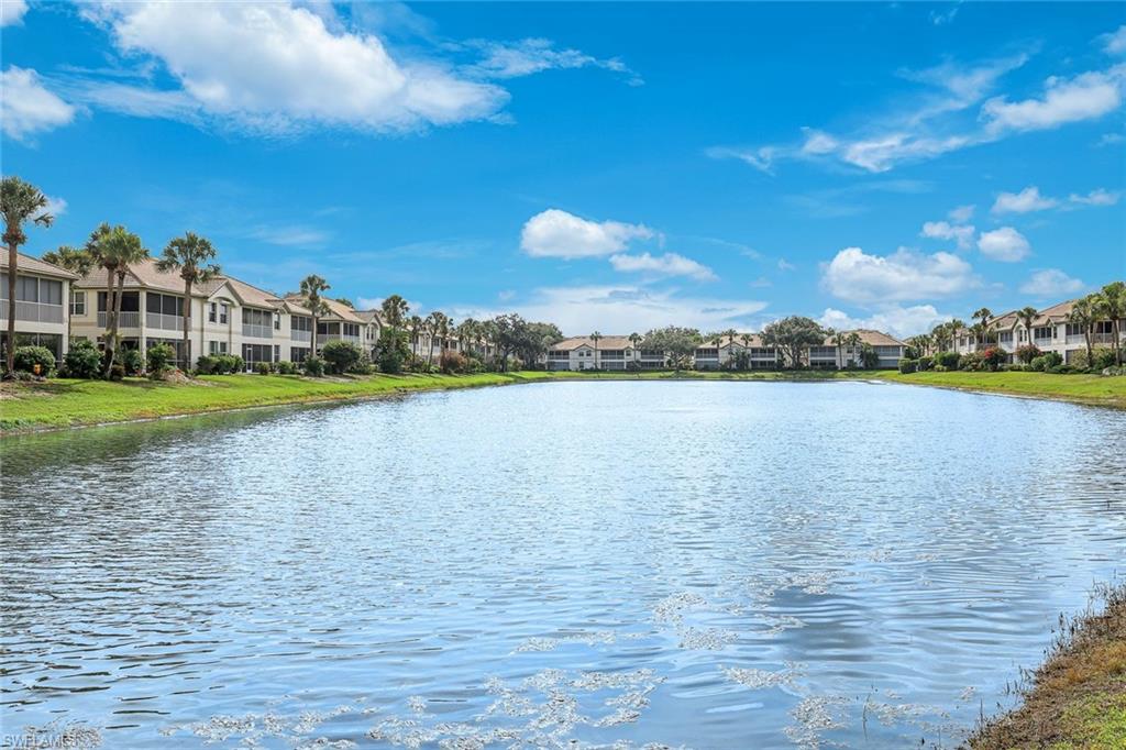 Waterfront residences featuring screened balconies and a lush green lawn