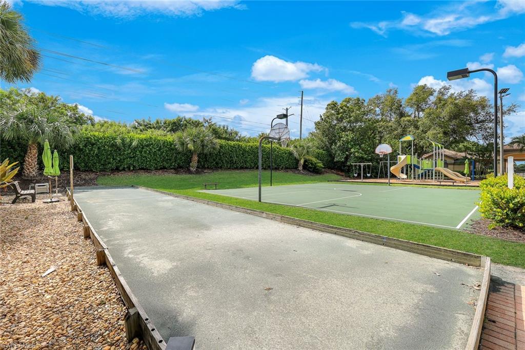 Recreational area featuring a bocce ball court, a basketball court, and a playground with slides and swings