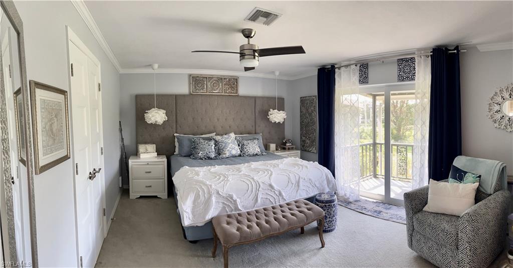 Primary Bedroom with King Bed, ensuite bathroom, carpet floors, access to balcony, sitting area with dresser and TV