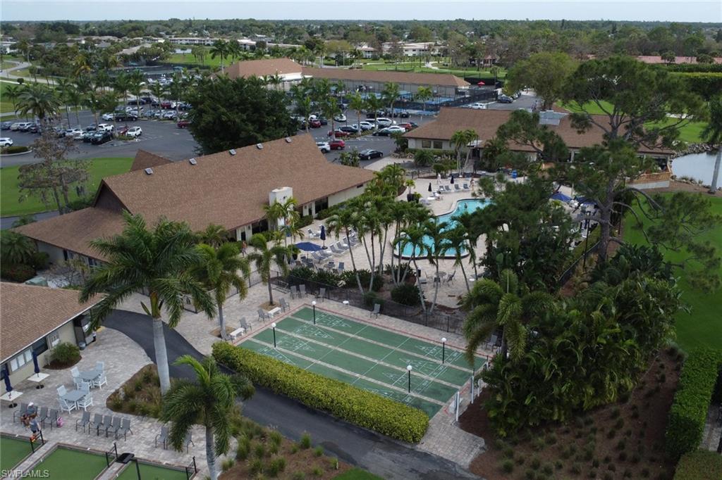 Aerial view of property's location featuring a pool area and shuffleboard