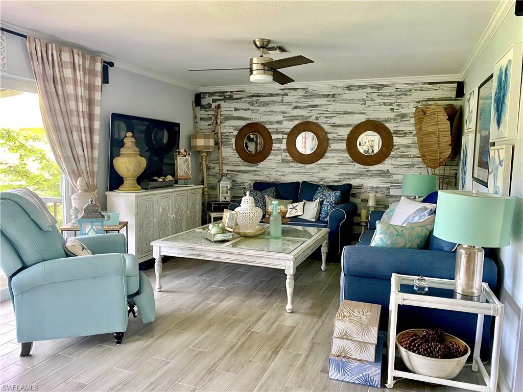 Spacious living room area with sofa, loveseat and recliner to relax and watch TV or step out to the enclosed balcony to watch the sunsets