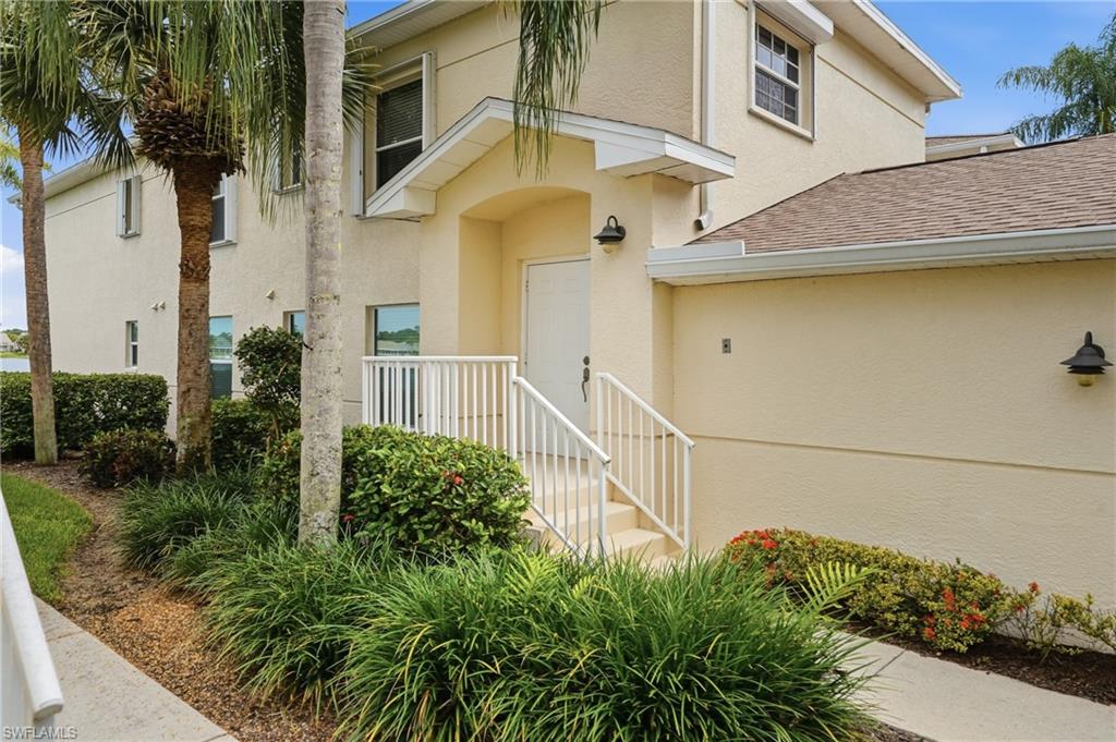Stucco exterior with a pitched shingle roof
