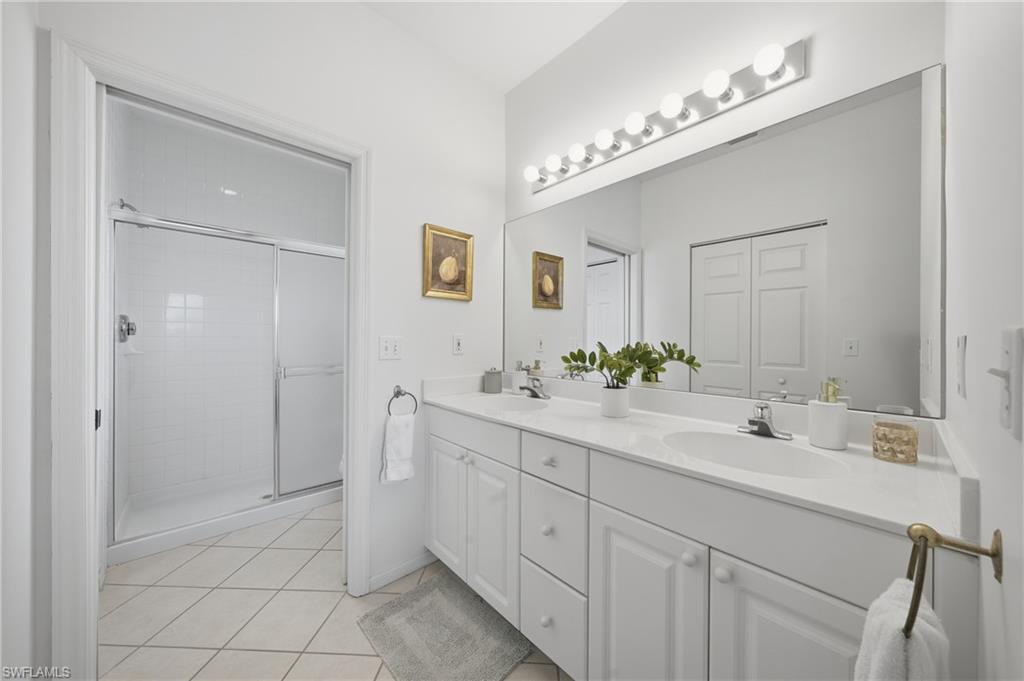 Dual vanity with white cabinetry and integrated sinks