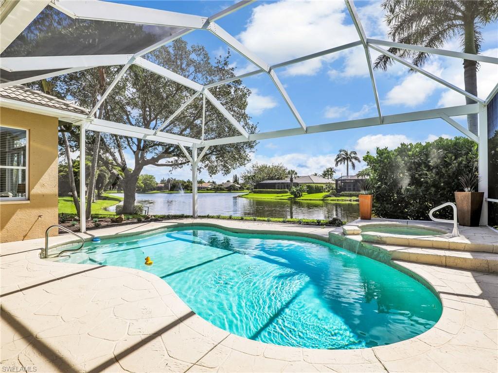 View of pool with a patio, a water view, and a lanai