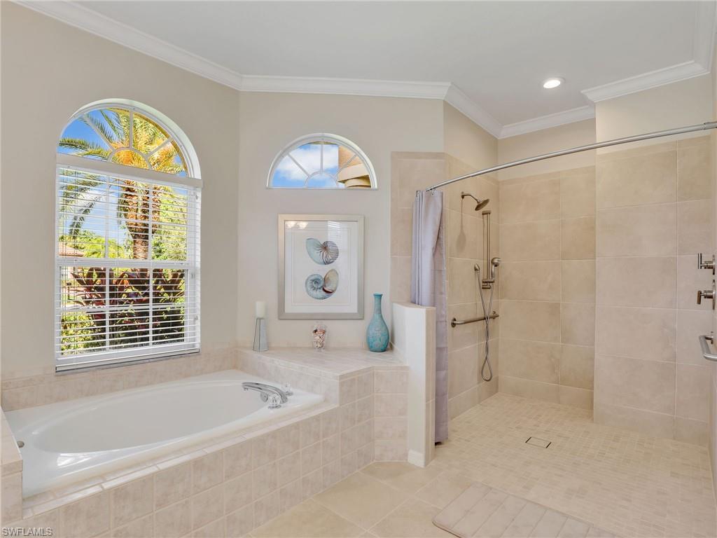 Full bath featuring tiled shower, a bath, tile patterned floors, and ornamental molding