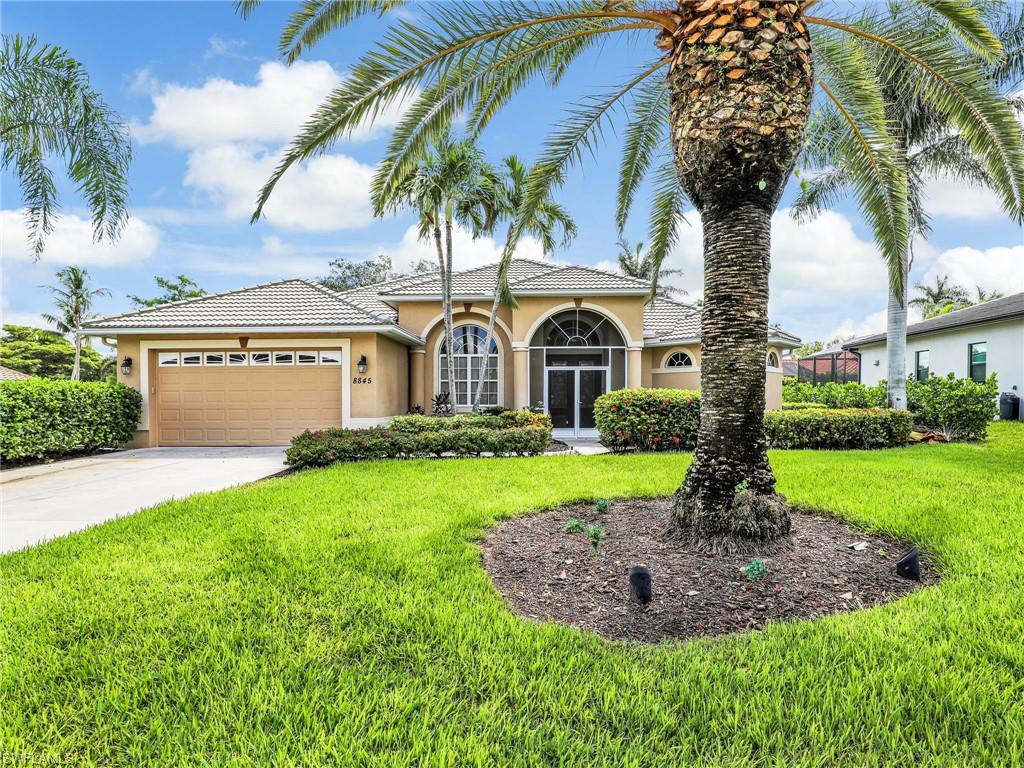 Mediterranean / spanish home featuring stucco siding, a garage, concrete driveway, and a front yard