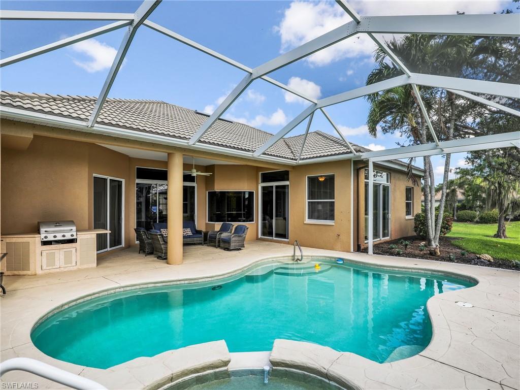 View of pool featuring a patio area, an outdoor hangout area, an outdoor kitchen, a pool with connected hot tub, and a ceiling fan