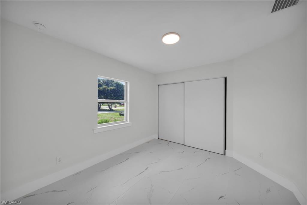 Bright room with white walls, white baseboards, and a single window