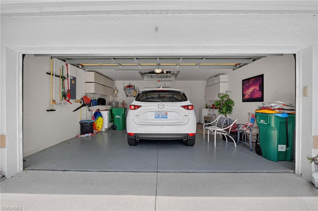 Garage has built in shelving, attic pulldown storage