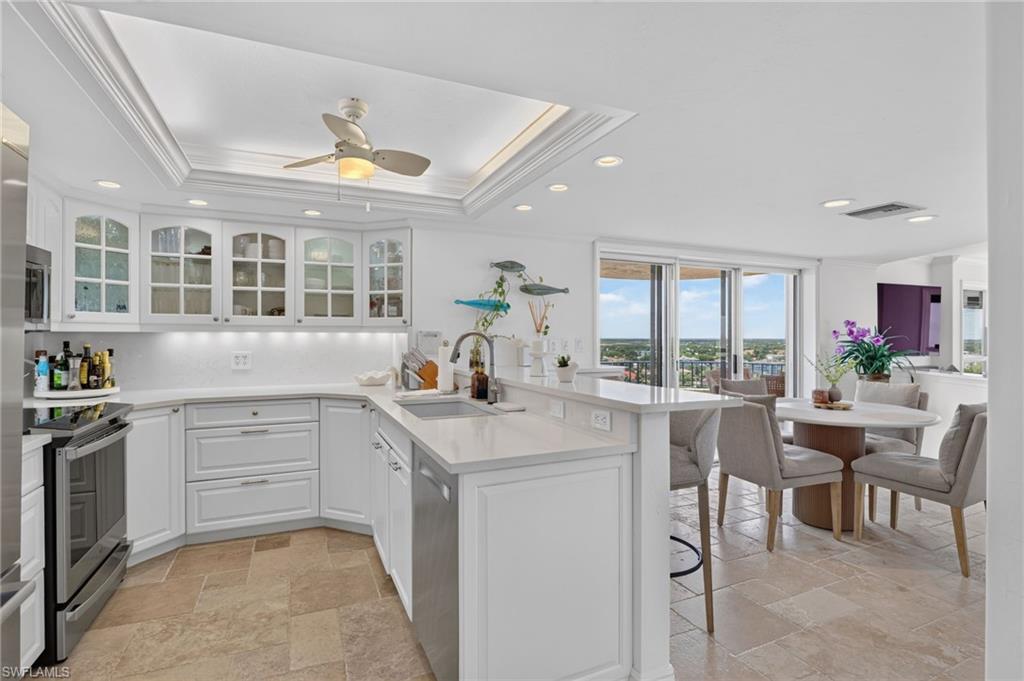 Kitchen opens to informal dining area and balcony overlooking the inner bay