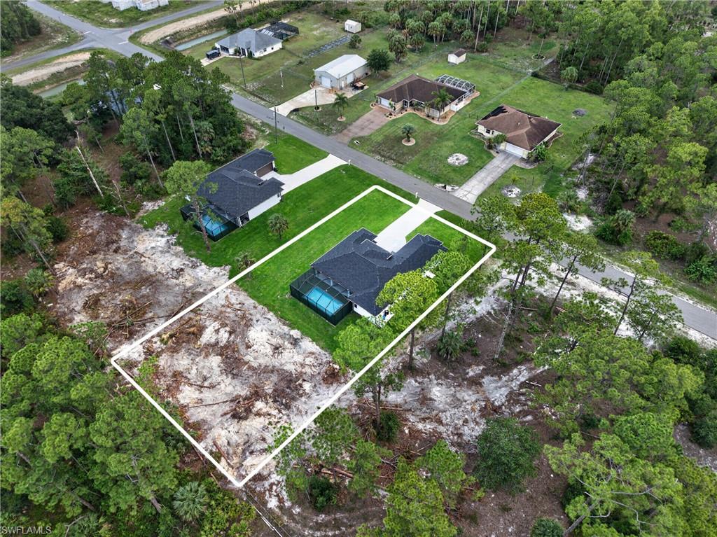 Cleared building lot bordered by mature trees