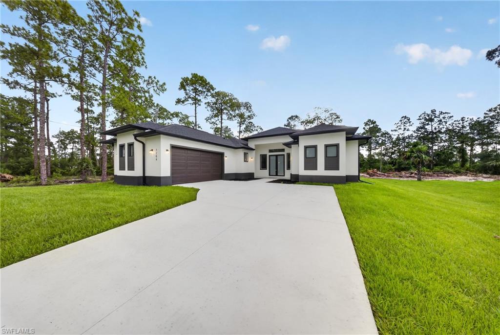 Modern architecture featuring a smooth stucco finish with dark trim accents