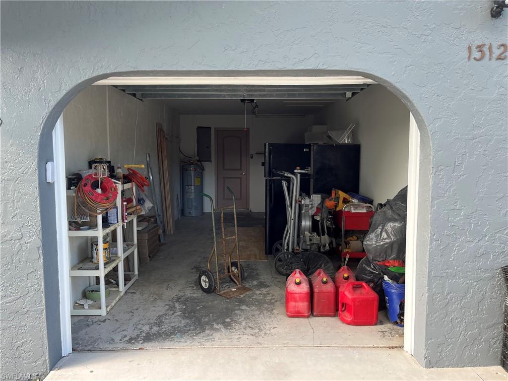 Garage featuring electric water heater and electric panel