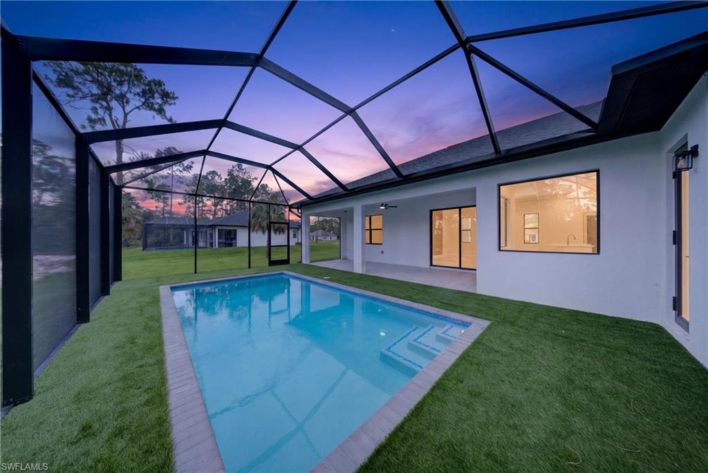 Screened-in swimming pool with a rectangular shape and integrated steps