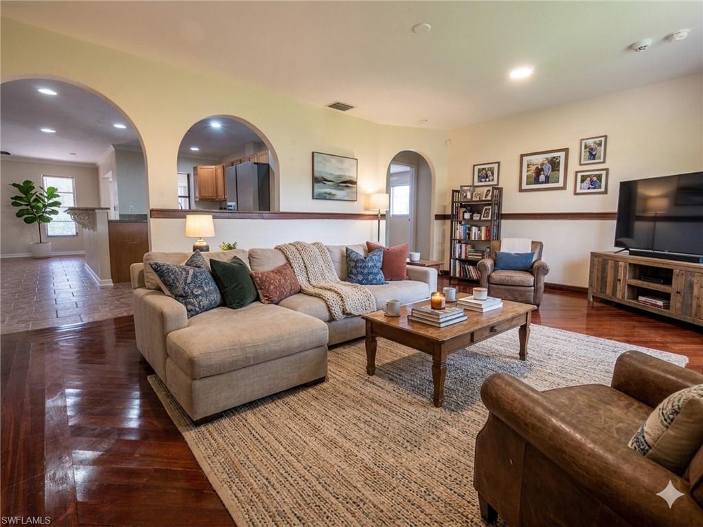 Living area featuring wood-finish flooring, recessed lighting, and a neutral color palette