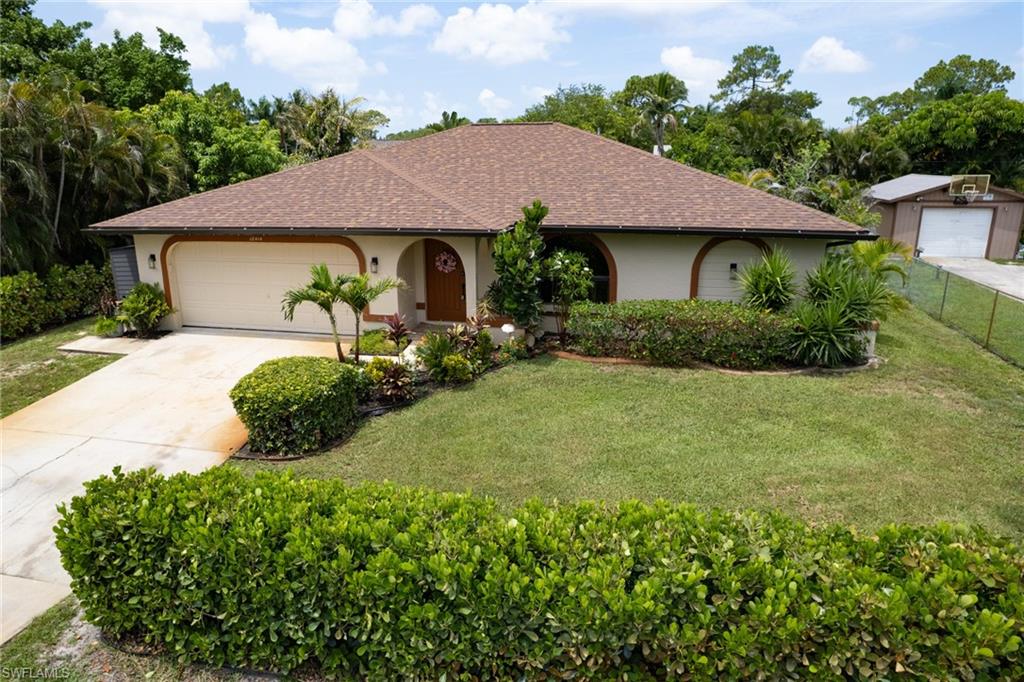 Single-story residence featuring a brown shingle roof and a two-car garage