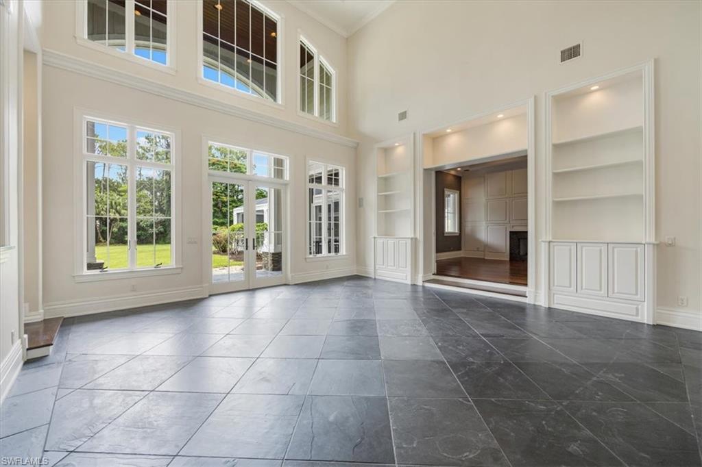 View of great room to family room and lawn of 5-acre estate and resort-style pool