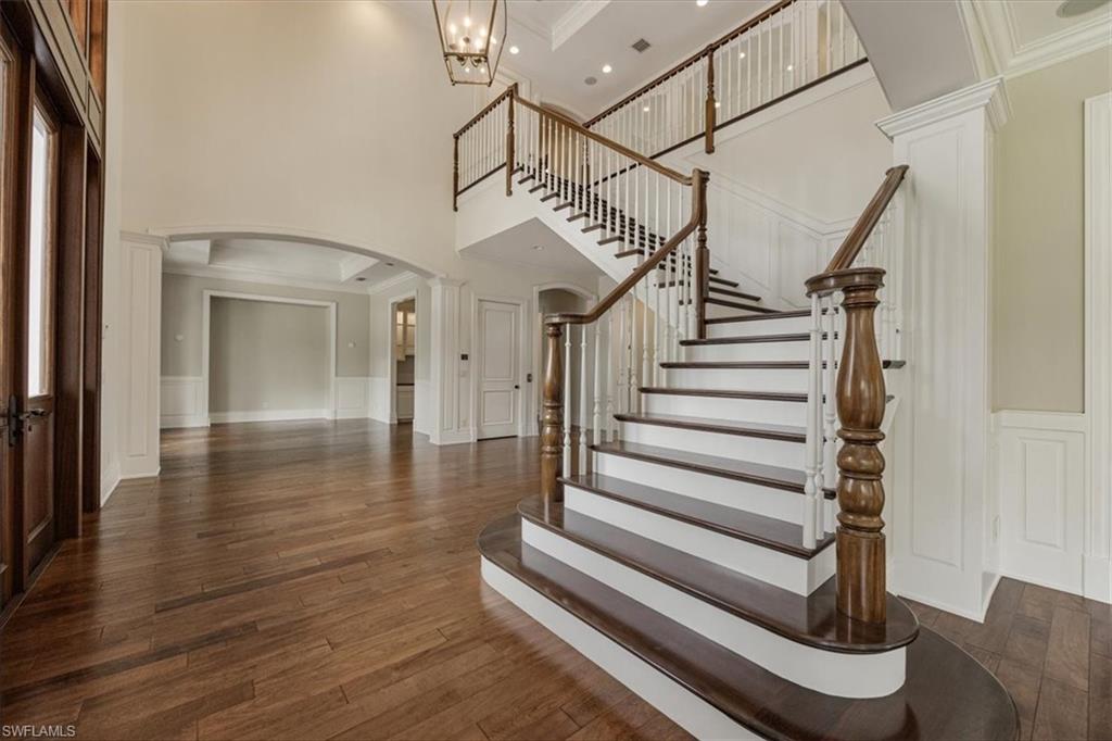Virtually staged. Grand foyer with 18' ceilings