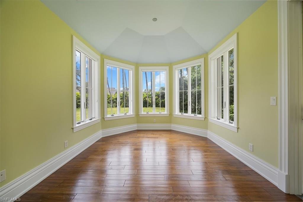 Virtually staged. Sunlit dining room overlooking estate lawn