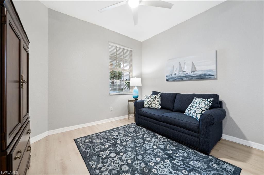 Living room featuring ceiling fan and light hardwood / wood-style flooring