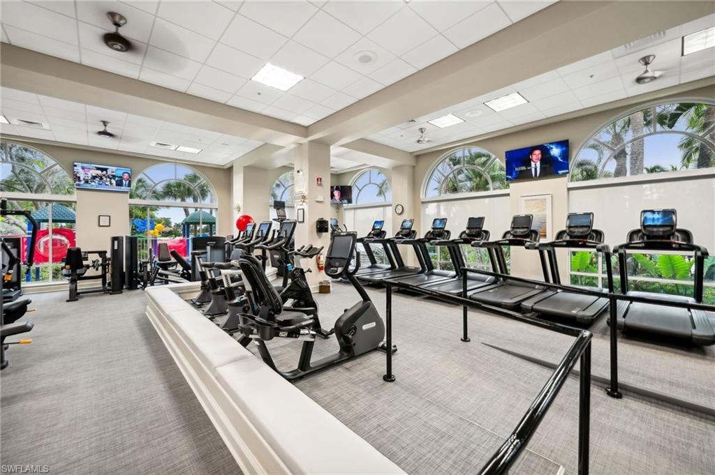 Gym with light colored carpet and a paneled ceiling